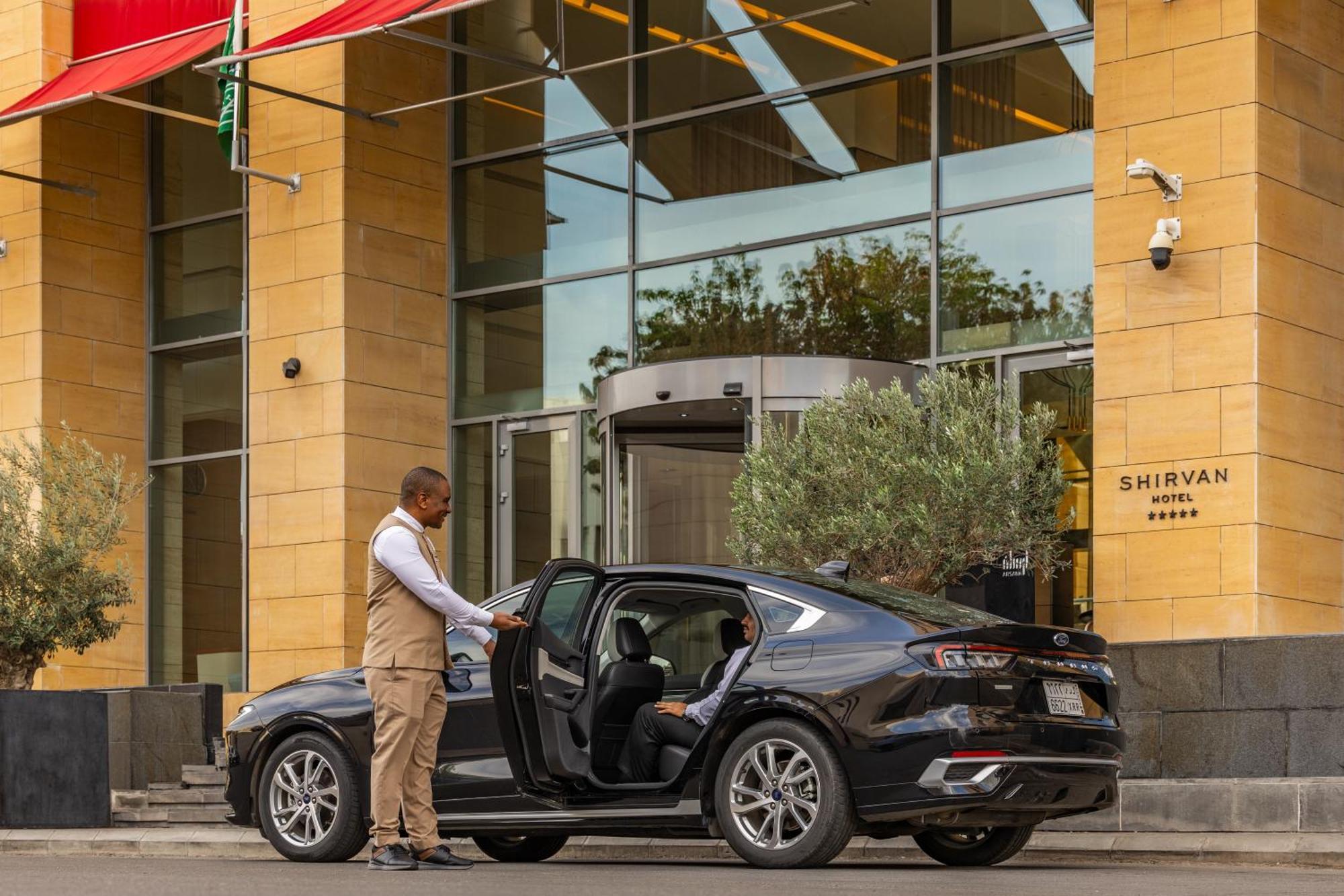 Shirvan Hotel City Yard Jidda Exteriör bild A chauffeur opening the door of a car
